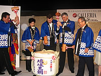 Ed Brennan (centre) leads the ceremonial opening of the sake barrels to bring good luck