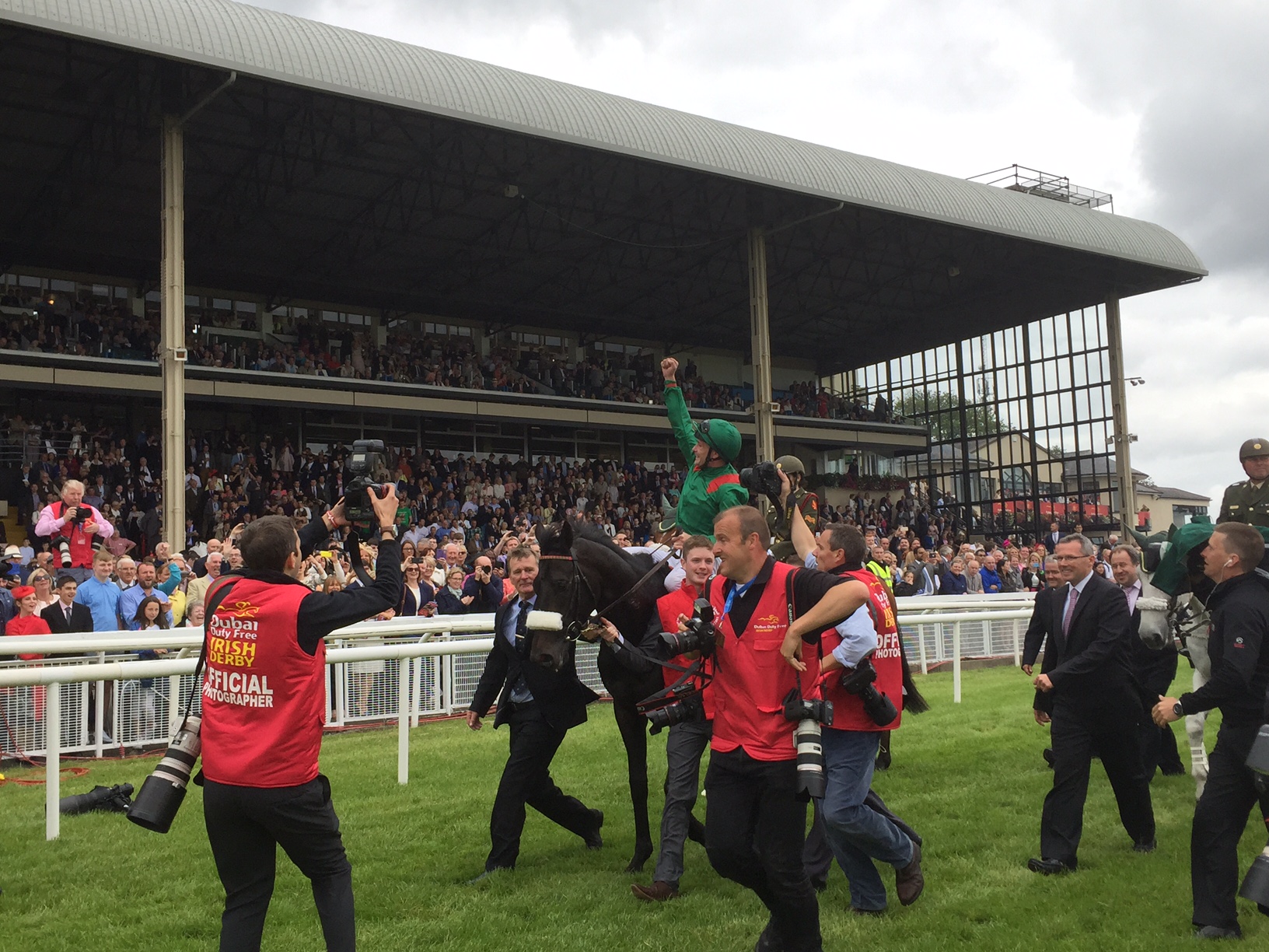Moment of triumph: Harzand's jockey Pat Smullen takes the acclaim of the crowd at The Curragh racecourse