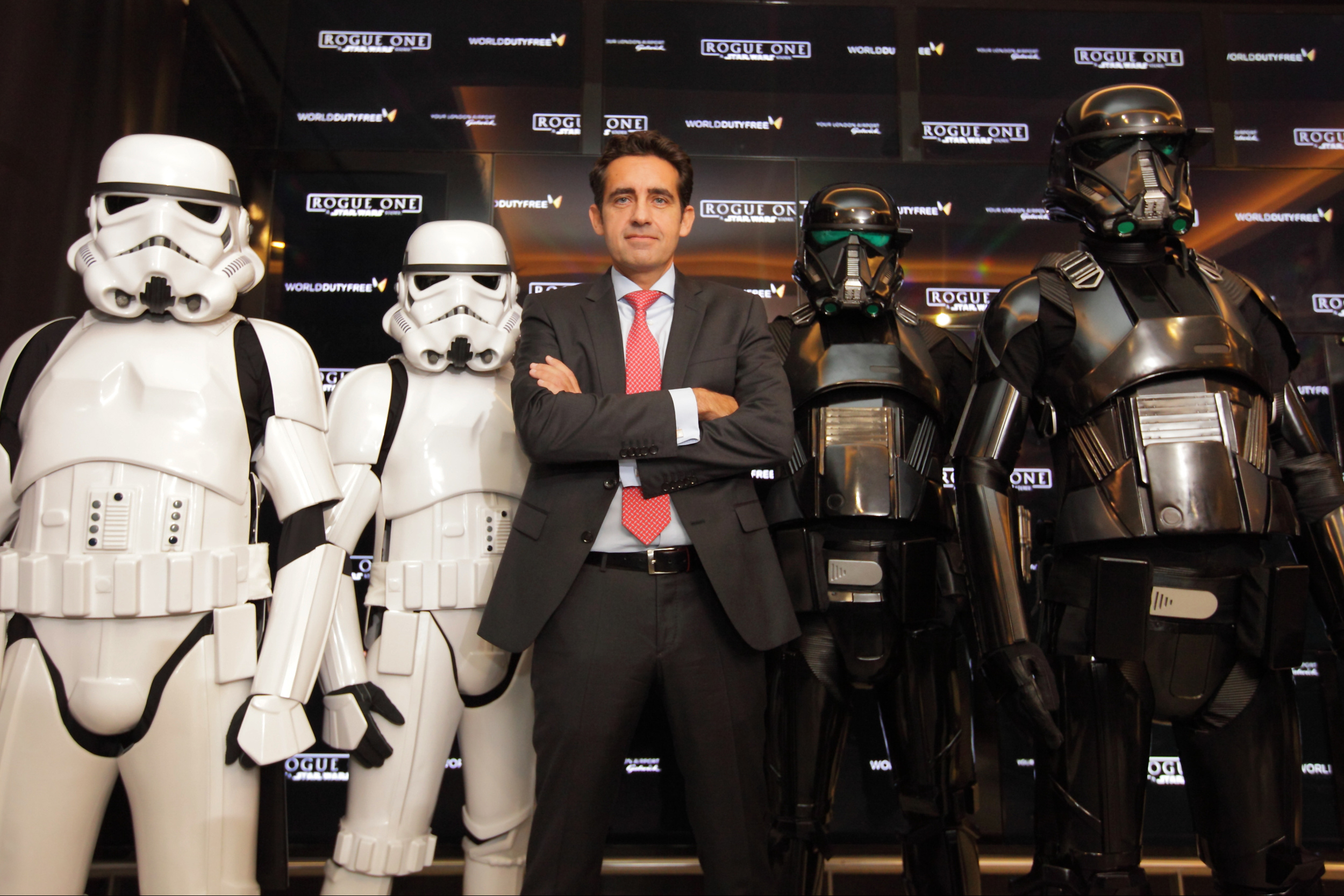 World Duty FreeÕs CEO, Eugenio Andrades, , guarded by stormtroopers and Death Troopers, in World Duty Free at Gatwick South today where passengers can experience Rogue One: A Star Wars Story ahead of the cinema release on 15th December