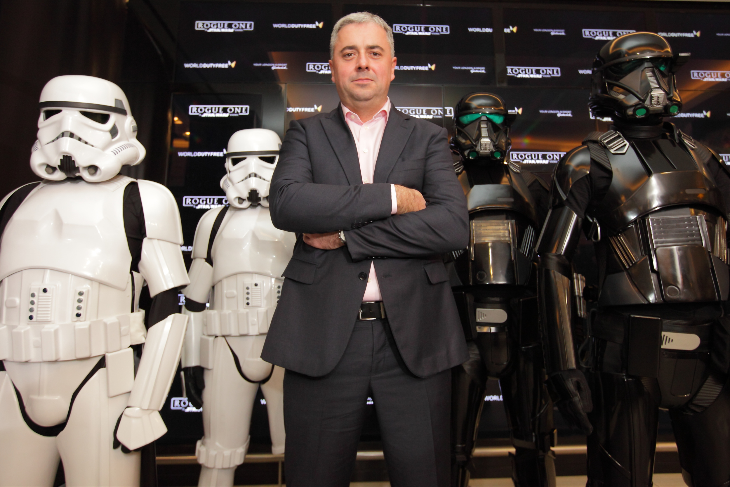 Gatwick's Chief Executive Stewart Wingate guarded by stormtroopers and Death Troopers, in World Duty Free at Gatwick South today where passengers can experience Rogue One: A Star Wars Story ahead of the cinema release on 15th December