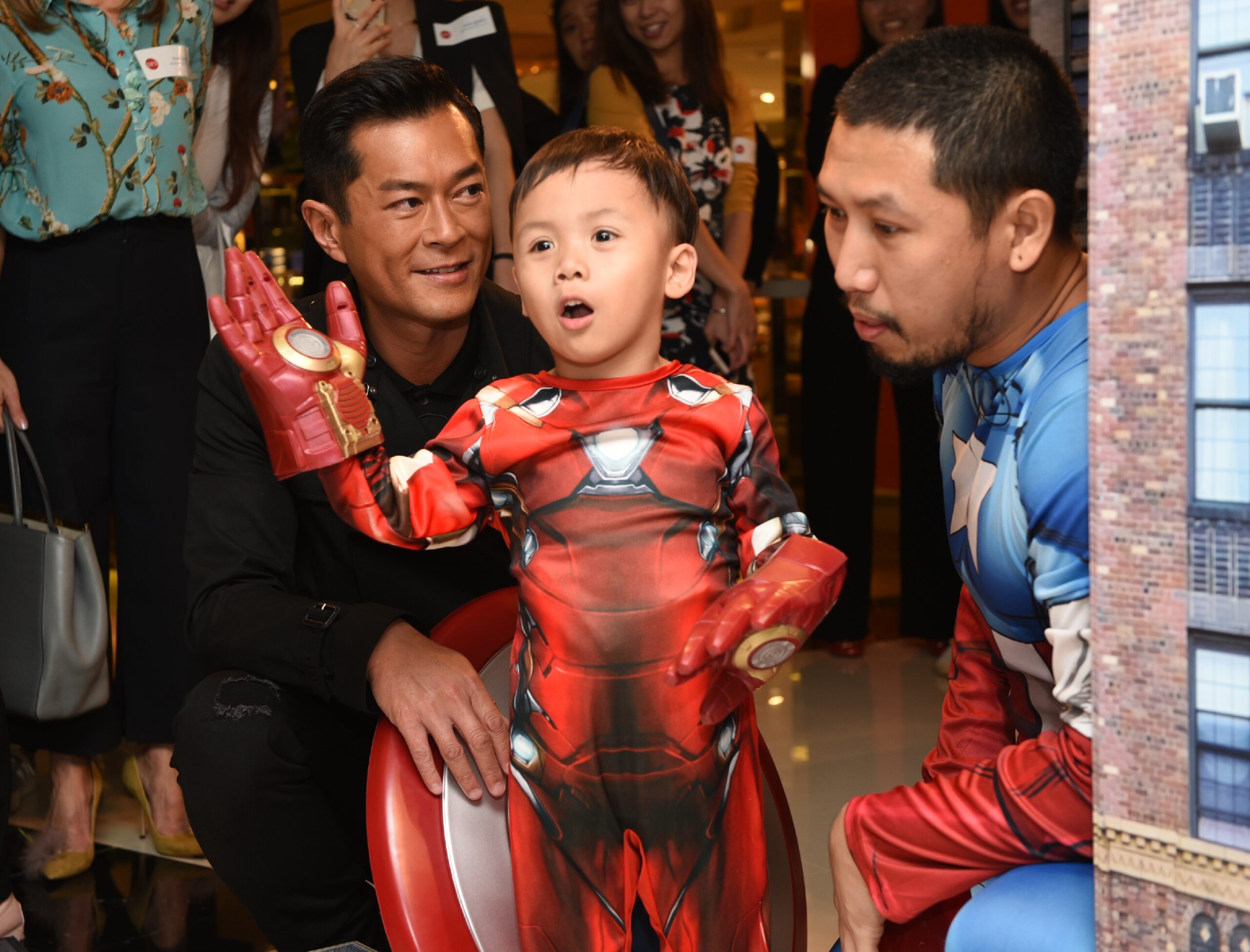 yuet-lun-along-with-hong-kong-actor-louis-koo-l-and-his-father-r-waves-to-the-crowd-of-fans-gathered-to-support-his-wish-of-being-a-superhero
