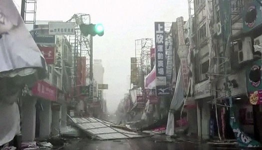 In this image made from video, wind-blown debris litters the street from Typhoon Nepartak in Taitung, south eastern Taiwan, Friday, July 8, 2016. Power was partially restored in Taiwan on Friday after Nepartak slammed into the island's eastern coast with ferocious winds and torrential rains, killing two people and injuring 72. (EBC via AP Video)